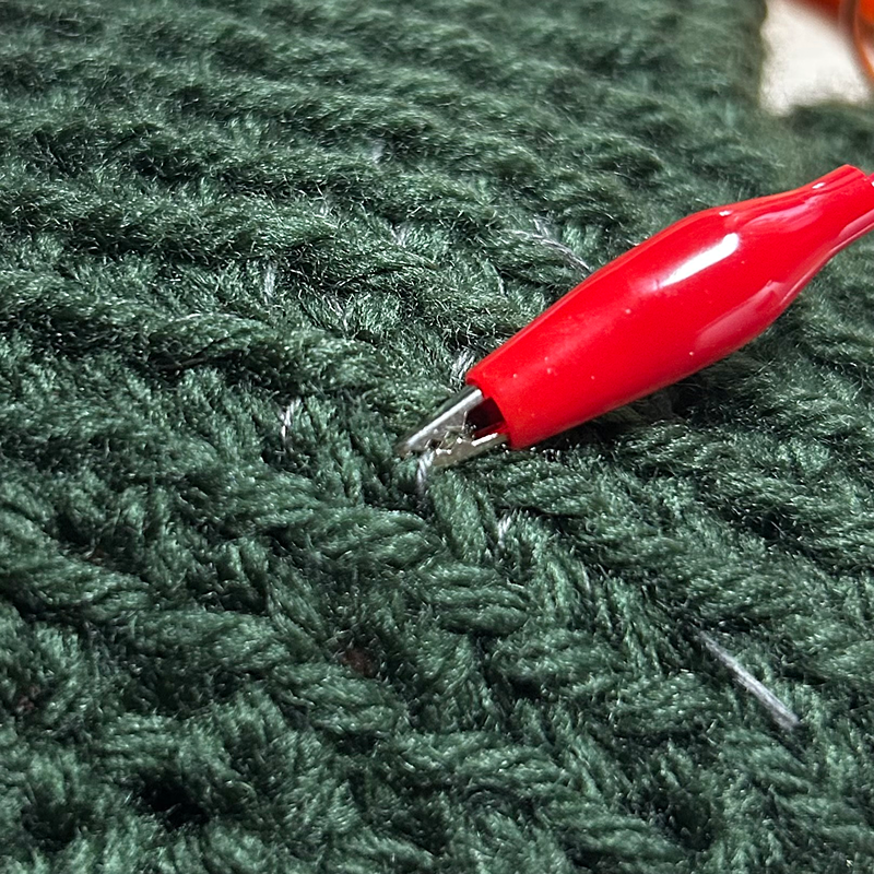 I clipped to a thread of conductive thread.